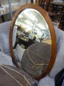 A BEVELLED EDGE OVAL WALL MIRROR, IN MAHOGANY FRAME