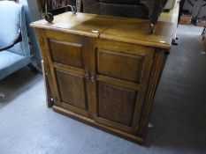 A GOOD QUALITY SOLID OAK HI-FI CUPBOARD WITH PART LIFT-UP LID, INTERIOR HAVING FITTED SHELVES,