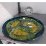 A GREEN AND GOLD STUDIO GLASS CIRCULAR PLAQUE, 12 ¼? DIAMETER AND A CLEAR GLASS GLOBULAR DOOR