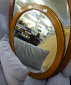 AN OVAL BEVELLED EDGE WALL MIRROR, IN MAHOGANY FRAME