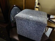 AN UPHOLSTERED SQUARE SMALL OTTOMAN BOX AND A MAHOGANY OVAL WALL MIRROR (2)