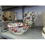 A LARGE FLORAL POTTERY TOILET WATER JUG AND A FLORAL POTTERY FRUIT BOWL (2)