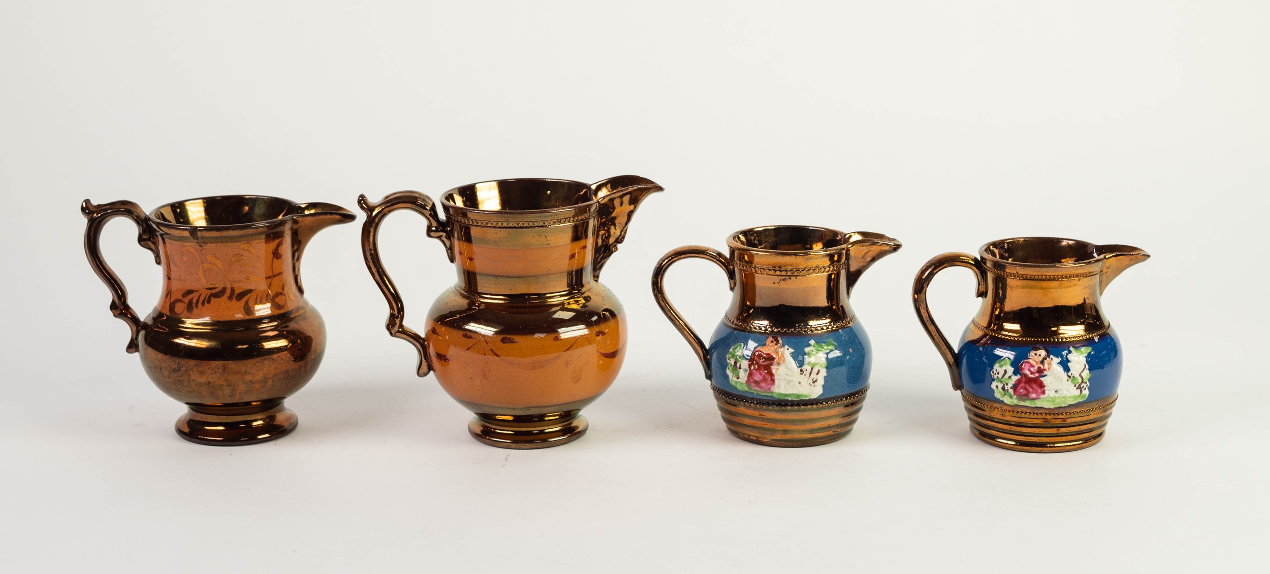 FOUR NINETEENTH CENTURY COPPER LUSTRE POTTERY JUGS, including a pair, 4 ½? (11.5cm) high ad smaller,