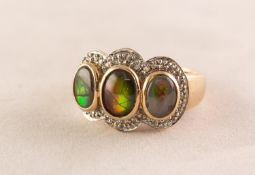 9ct GOLD DRESS RING, collet set with three oval cabochons and surround of tiny white stones, 7.5gms,