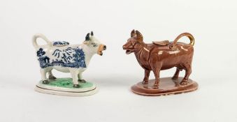 NINETEENTH CENTURY BLUE AND WHITE POTTERY COW CREAMER, on rounded oblong base, together with a BROWN