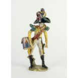 ITALIAN POTTERY MODEL OF A MILITARY BANDSMAN, painted in colours and gilt, and modelled with side