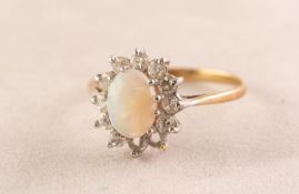 9ct GOLD CLUSTER RING, set with a cabochon oval opal and surround of eleven white cubic zirconia (