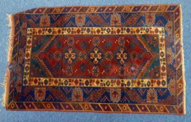 TURKISH ANATOLIAN PRAYER RUG, with orange and black flower pattern on the narrow oblong field,