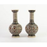 PAIR OF SIMON PETER GERZ, GERMAN MOULDED STONEWARE VASES, each of globe and shaft form with cupped