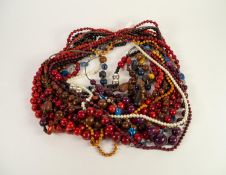 SIXTEEN SINGLE STRAND BEAD NECKLACES, mainly long necklaces with graduated stained wood beads (16)