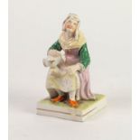 NINETEENTH CENTURY STAFFORDSHIRE POTTERY FIGURE, painted in colours and modelled as a seated maid