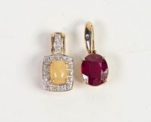 9ct GOLD PENDANT set with an oval garnet and a tiny diamond; 9ct GOLD PENDANT set with a cabochon