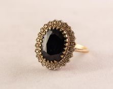 9ct GOLD CLUSTER RING, set with a large centre oval dark blue stone and surround of twenty four tiny