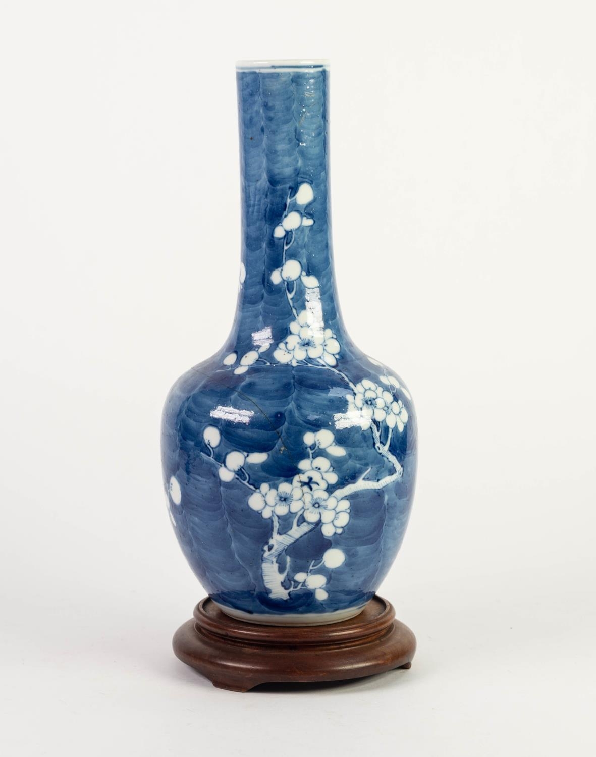 CHINESE BLUE AND WHITE PORCELAIN BOTTLE VASE, painted with prunus on a cracked ice ground, 12? (30.