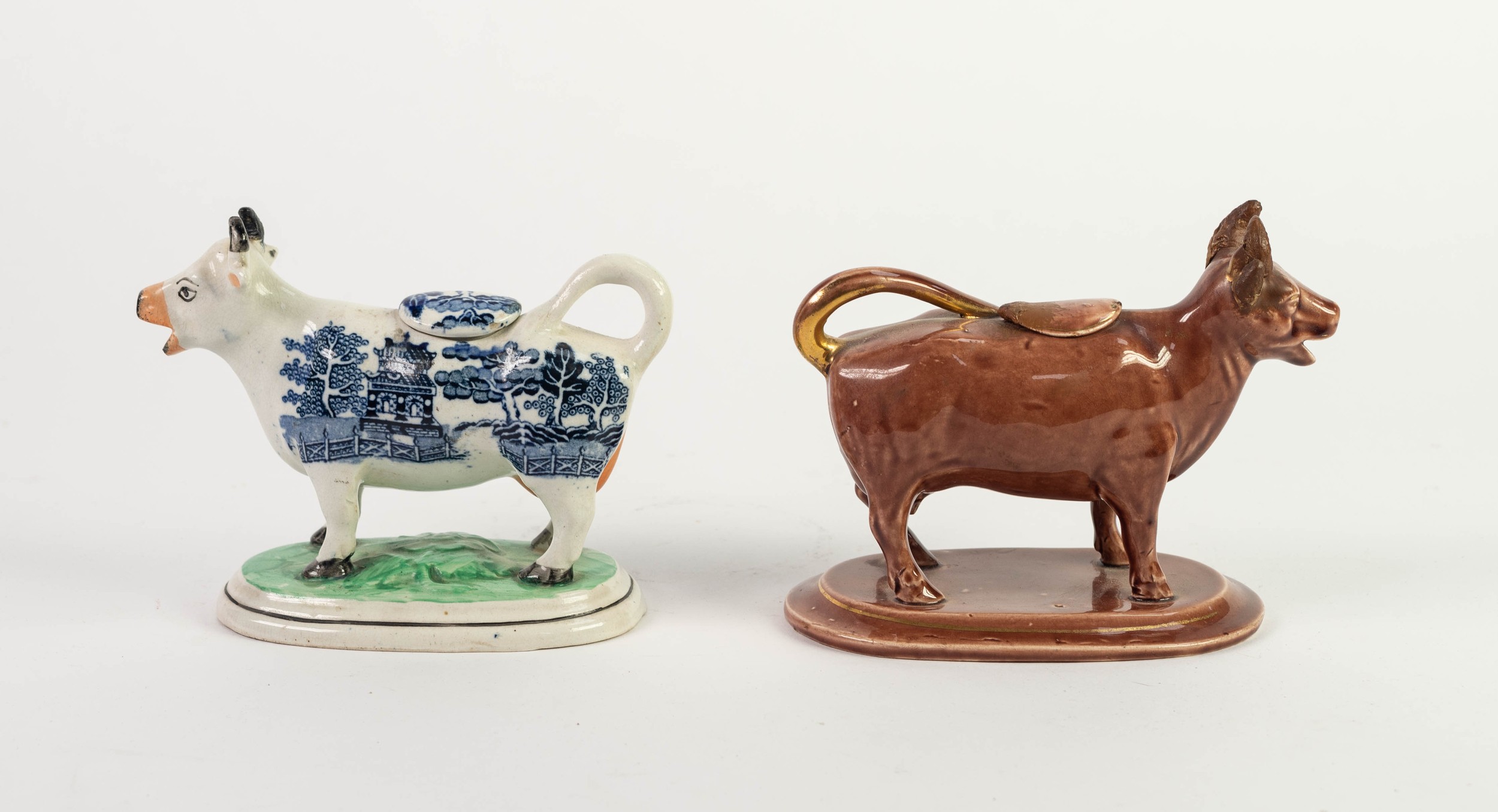 NINETEENTH CENTURY BLUE AND WHITE POTTERY COW CREAMER, on rounded oblong base, together with a BROWN - Image 2 of 2