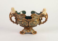 PROBABLY METTLACH MOULDED POTTERY TWO HANDLED PEDESTAL BOWL, of boat form with winged cherub