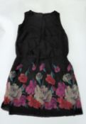 1920s BLACK SILK SLEEVELESS DRESS with round neck, the lower third printed with large pink and white