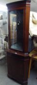 A LINE INLAID MAHOGANY DOUBLE CORNER CABINET WITH GLAZED DOOR ABOVE, ENCLOSING A MIRRORED INTERIOR