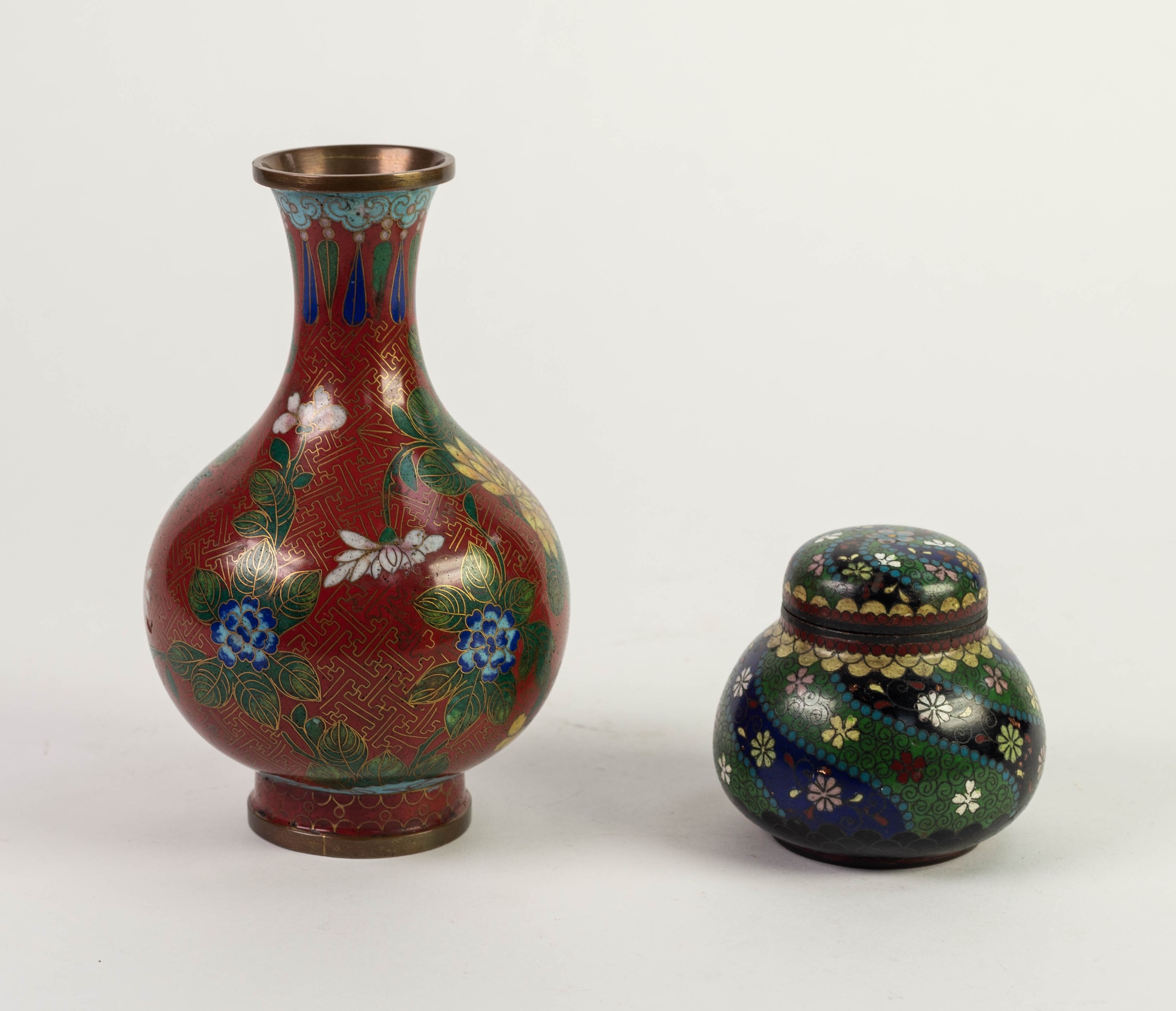 ORIENTAL CLOISONNE JAR AND COVER, decorated in colours with stylised flowerheads on blue and green