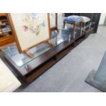 WEGNER STYLE BLACK LACQUERED COFFEE TABLE AND PAIR OF LAMP TABLES, EACH WITH A GLASS TOP, ON METAL