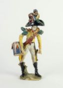 ITALIAN POTTERY MODEL OF A MILITARY BANDSMAN, painted in colours and gilt, and modelled with side