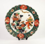 JAPAN LATE MEIJI PERIOD PORCELAIN PLAQUE, of typical form with scalloped rim, painted in colours and