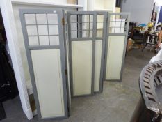 PAIR OF THREE-FOLD PRIVACY SCREENS, WITH A NINE PANE UPPER SECTION AND PANEL  BELOW, PAINTED IN GREY