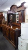A SUBSTANTIAL EARLY TWENTIETH CENTURY MAHOGANY SIDEBOARD WITH RAISED MIRROR BACK ON SHORT CABRIOLE