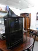 AN EDWARDIAN OAK PLANT STAND AND A SMALL GLASS FRONTED CORNER CUPBOARD (2)