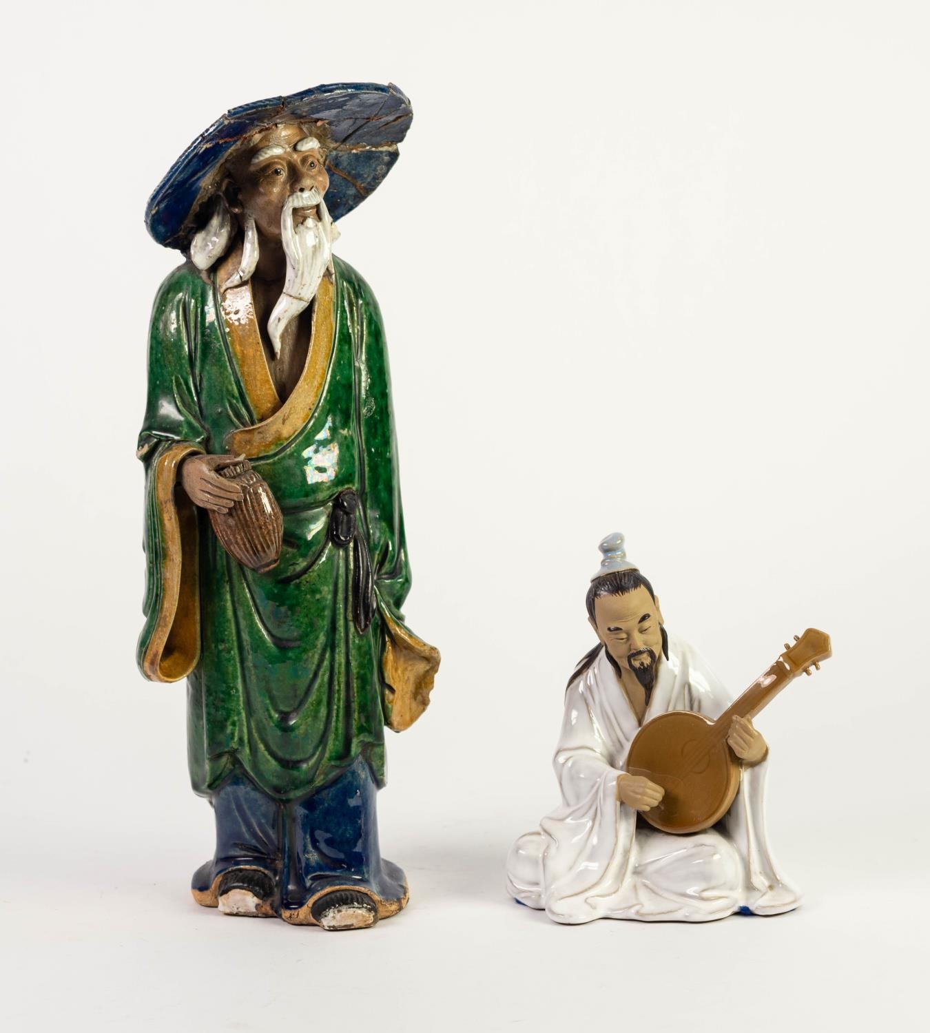 TWO ORIENTAL PART GLAZED PORCELAIN FIGURES, one modelled as an elderly man with brimmed hat,