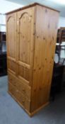 A MODERN GOOD QUALITY PINE TWO DOOR WARDROBE, WITH TWO DRAWERS BELOW, HAVING TONGUE AND GROOVE