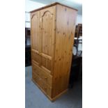 A MODERN GOOD QUALITY PINE TWO DOOR WARDROBE, WITH TWO DRAWERS BELOW, HAVING TONGUE AND GROOVE