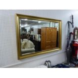 AN OBLONG FRAMED WALL MIRROR (100cm x 70cm)