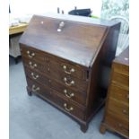 GEORGE III MAHOGANY BUREAU WITH SLOPING FALL FRONT OVER FOUR GRADUATED LONG DRAWERS AND BRACKET