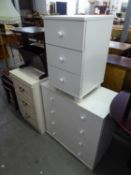 TWO WHITE FINISH CHESTS OF DRAWERS AND A SIMILAR BEDSIDE CHEST OF THREE DRAWERS