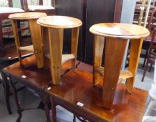 A SET OF THREE SMALL CIRCULAR COFFEE TABLES, EACH ON THREE PROPELLER LEGS, JOINED BY AN UNDER