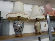 TWO SIMILAR FLORAL PAINTED POTTERY VASE SHAPED TABLE LAMPS, with turned wood bases and matching