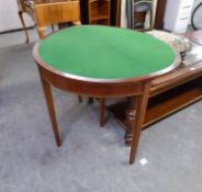 A MAHOGANY INLAID DEMI-LUNE CARD/GAMES TABLE, THE FOLDING TOP REVEALING A GREEN BAIZE, RAISED ON