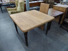 A MAHOGANY DINING TABLE, HAVING EXTRA LEAF, RAISED ON TURNED SUPPORTS (TOP STRIPPED AND FIXED)