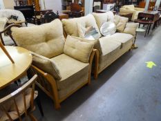 A LIGHT WOOD ERCOL STYLE WOOD FRAMED LOUNGE SUITE OF TWO PIECES, VIZ A THREE SEATER SETTEE AND A