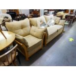 A LIGHT WOOD ERCOL STYLE WOOD FRAMED LOUNGE SUITE OF TWO PIECES, VIZ A THREE SEATER SETTEE AND A