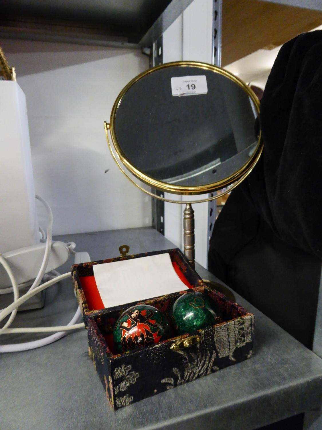 A GILT METAL FRAMED OVAL TOILET MIRROR AND A PAIR OF CHINA CLOISONNÉ BALLS, IN CASE