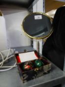 A GILT METAL FRAMED OVAL TOILET MIRROR AND A PAIR OF CHINA CLOISONNÉ BALLS, IN CASE