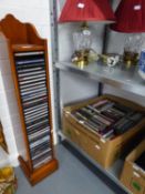 A COLLECTION OF DVD'S AND CD'S AND THE TALL STORAGE RACK