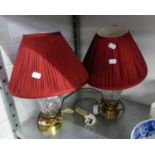 A PAIR OF WATERFORD CUT GLASS VASE TABLE LAMPS, WITH BRASS BASES AND RED PLEATED FABRIC SHADES