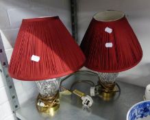 A PAIR OF WATERFORD CUT GLASS VASE TABLE LAMPS, WITH BRASS BASES AND RED PLEATED FABRIC SHADES