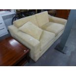A GOOD QUALITY TWO SEATER SOFA, COVERED IN BEIGE FABRIC WITH LOOSE CUSHIONS