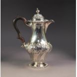 VICTORIAN SILVER PYRIFORM COFFEE POT, repousse with flowers rococo scrolls, the hinged domed lid