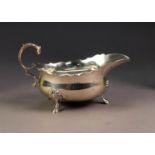 GEORGIAN STYLE SILVER SAUCE BOAT, with cyma edges, acanthus free scroll handle , on three shell