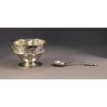 GEORGE V ARTS AND CRAFTS EMBOSSED AND PLANISHED SILVER PEDESTAL CHILD?S BOWL AND SPOON BY A.E.